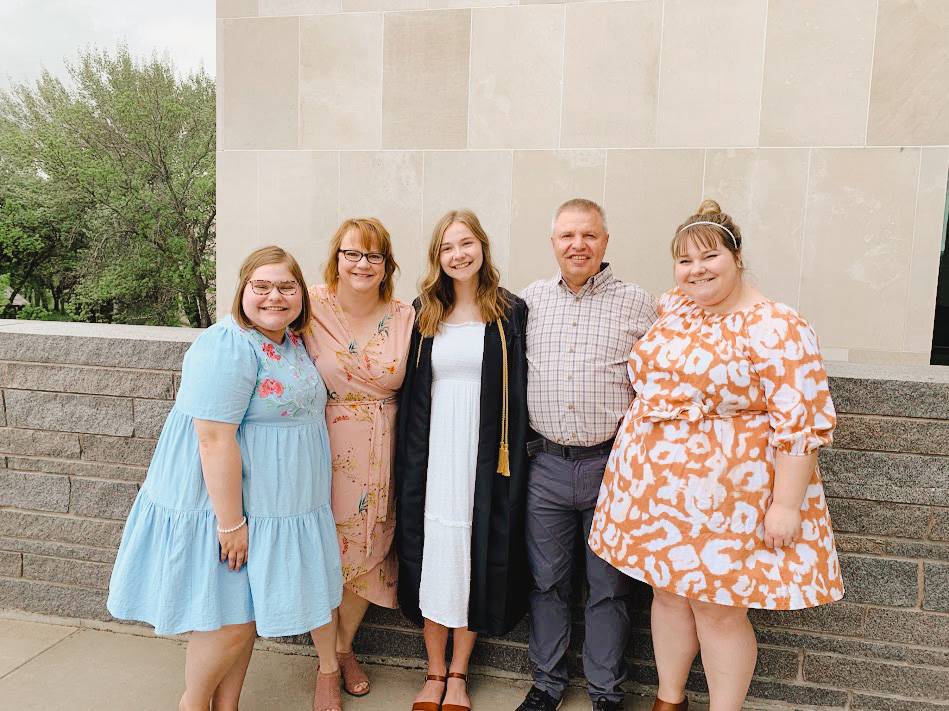 Amber posed with her family at a graduation ceremony.